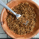 Bowl of mealworms with fork